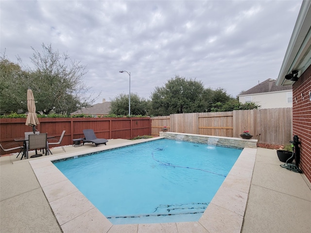 view of swimming pool with a patio area