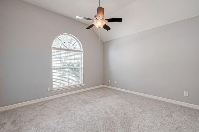 carpeted spare room with lofted ceiling and ceiling fan