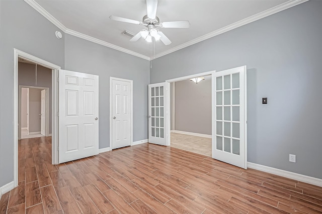 empty room featuring french doors, ceiling fan, crown molding, and light wood-type flooring