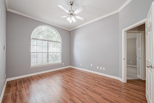 spare room featuring wood-type flooring, crown molding, and ceiling fan