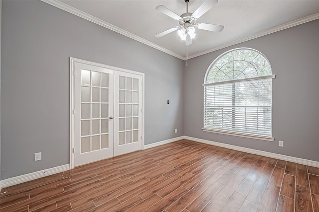 spare room featuring wood-type flooring, ornamental molding, ceiling fan, and french doors