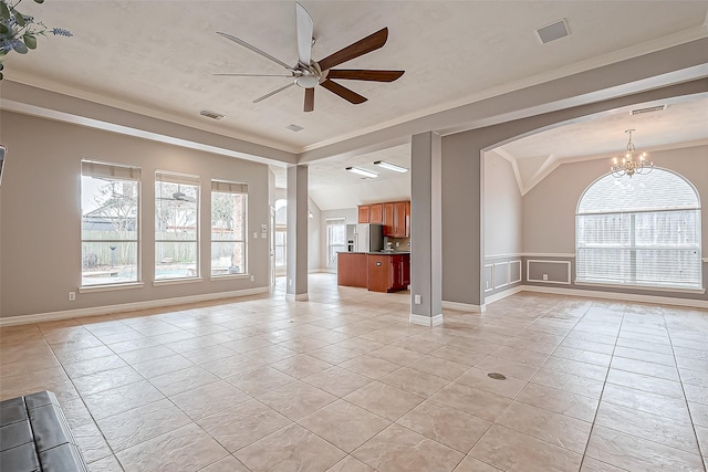 unfurnished living room with crown molding, ceiling fan with notable chandelier, and light tile patterned floors