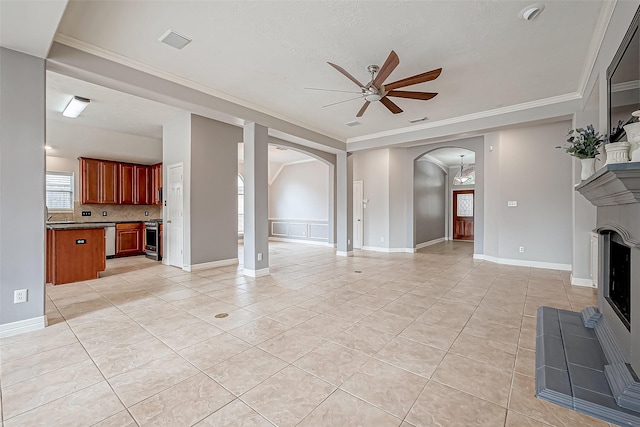 unfurnished living room featuring crown molding, ceiling fan, and light tile patterned floors