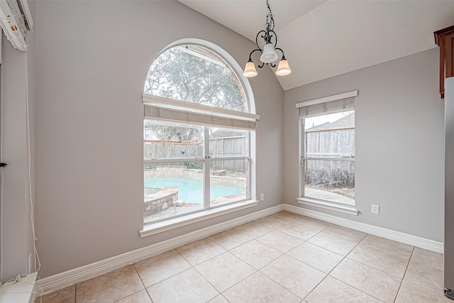 spare room with lofted ceiling, light tile patterned floors, and a notable chandelier