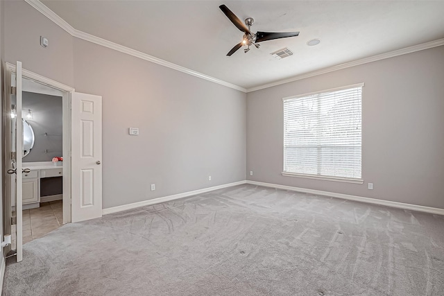 empty room featuring crown molding, light carpet, and ceiling fan