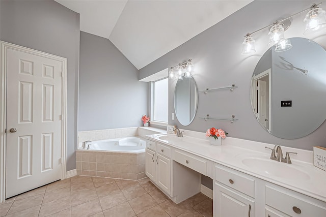 bathroom with vanity, tile patterned flooring, vaulted ceiling, and tiled tub