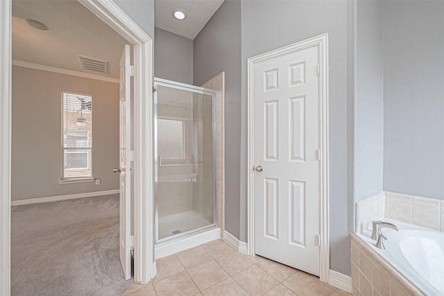 bathroom featuring independent shower and bath, ornamental molding, and tile patterned floors