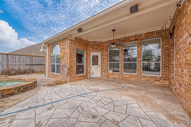 view of patio / terrace featuring an in ground hot tub and ceiling fan