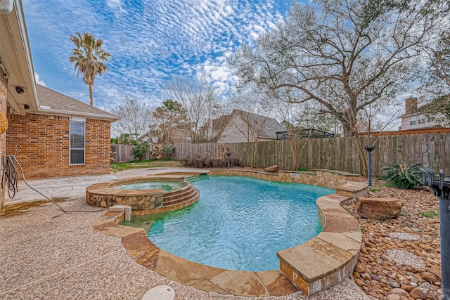 view of pool featuring a patio area and an in ground hot tub