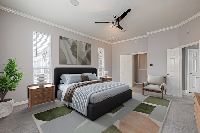 carpeted bedroom with ceiling fan and ornamental molding