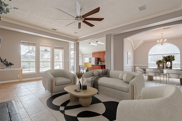 living room with crown molding, ceiling fan with notable chandelier, and a wealth of natural light