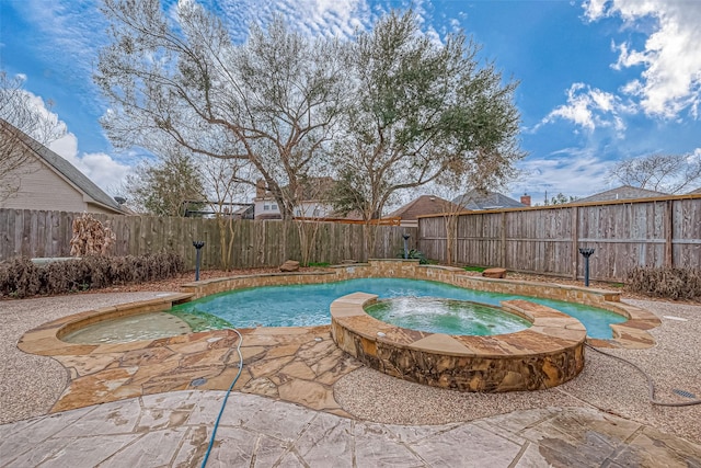 view of swimming pool featuring a patio and an in ground hot tub