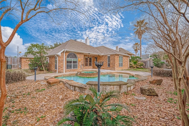 view of pool with an in ground hot tub and a patio area