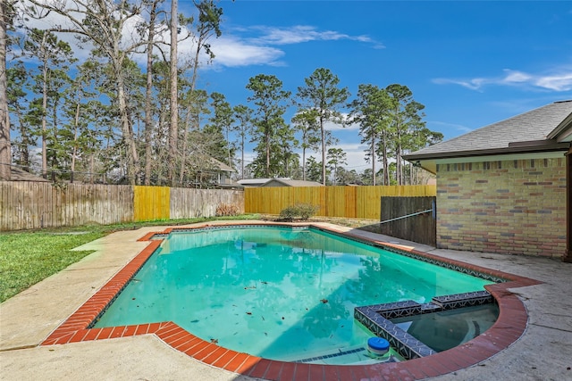 view of pool featuring a pool with connected hot tub and a fenced backyard