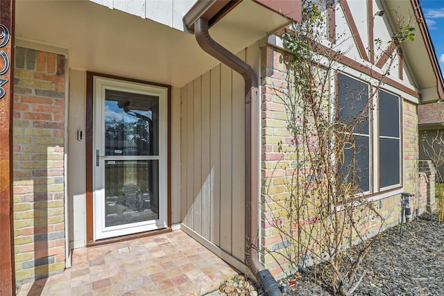 property entrance with brick siding