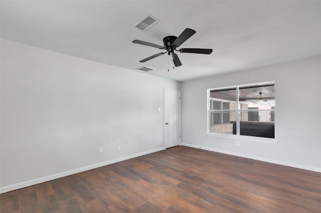 spare room featuring ceiling fan and dark hardwood / wood-style flooring