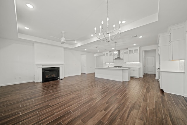 906 Hooks Trl, League City, TX 77573 - unfurnished living room featuring sink, dark hardwood / wood-style flooring, a raised ceiling, and ceiling fan with notable chandelier