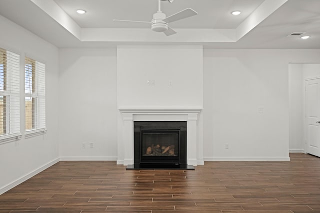 906 Hooks Trl, League City, TX 77573 - unfurnished living room featuring a tray ceiling, dark hardwood / wood-style floors, and ceiling fan