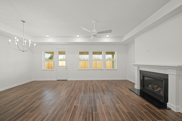 906 Hooks Trl, League City, TX 77573 - unfurnished living room featuring dark hardwood / wood-style flooring, a tray ceiling, and ceiling fan with notable chandelier