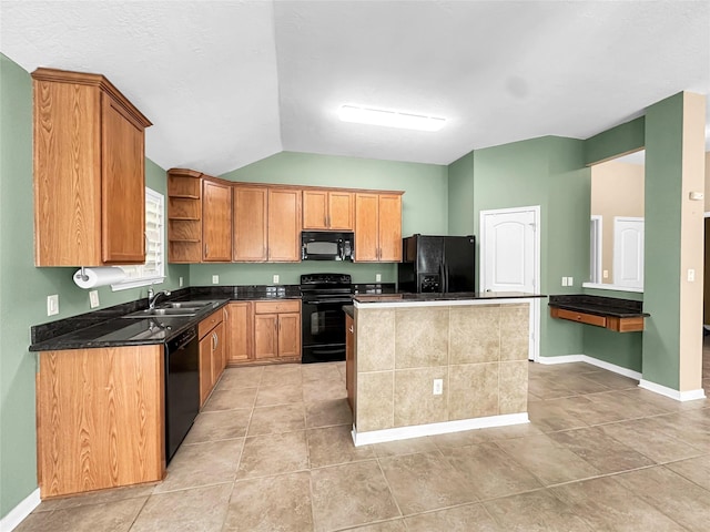 kitchen featuring sink, light tile patterned floors, a center island, black appliances, and vaulted ceiling