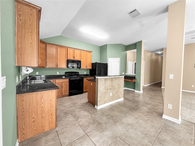 kitchen with lofted ceiling, sink, light tile patterned floors, a center island, and black appliances