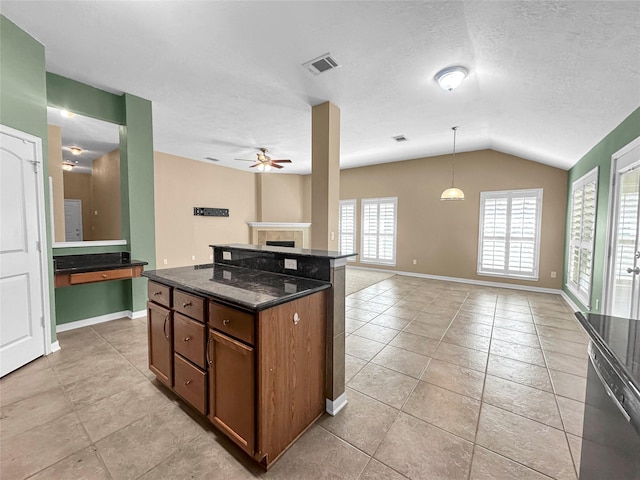 kitchen with vaulted ceiling, pendant lighting, dishwashing machine, dark stone counters, and a center island