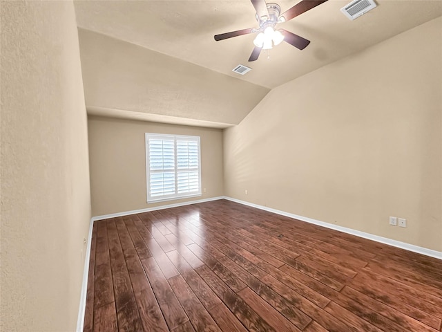 spare room featuring wood-type flooring, lofted ceiling, and ceiling fan