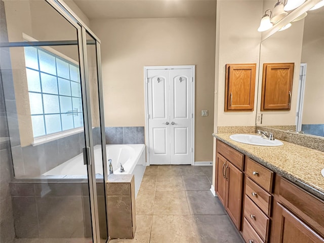 bathroom with tile patterned floors, shower with separate bathtub, and vanity