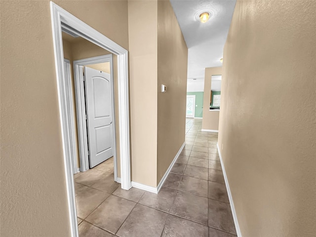 corridor featuring light tile patterned floors