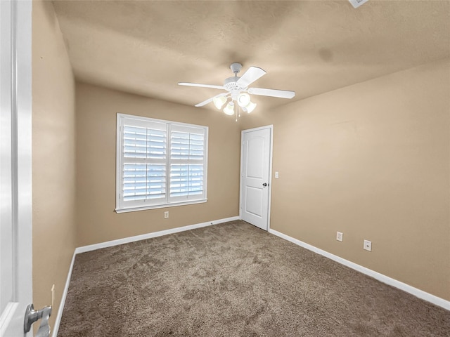 carpeted empty room featuring ceiling fan