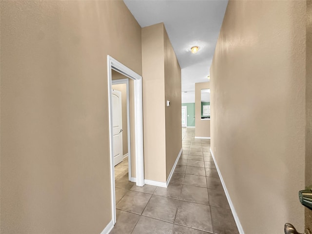 corridor featuring light tile patterned flooring