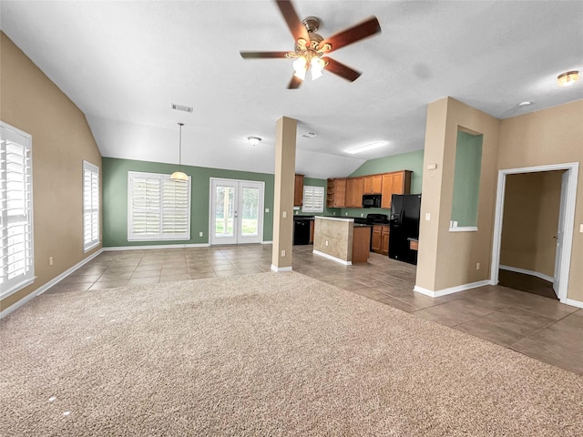 unfurnished living room with vaulted ceiling, french doors, ceiling fan, and light tile patterned flooring