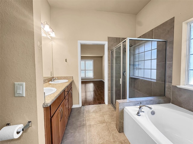 bathroom featuring tile patterned floors, vanity, and separate shower and tub