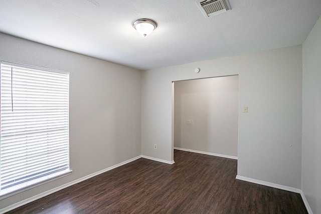 spare room featuring dark hardwood / wood-style flooring