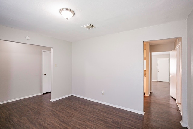 empty room with dark hardwood / wood-style floors