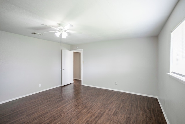 unfurnished room with dark wood-type flooring and ceiling fan