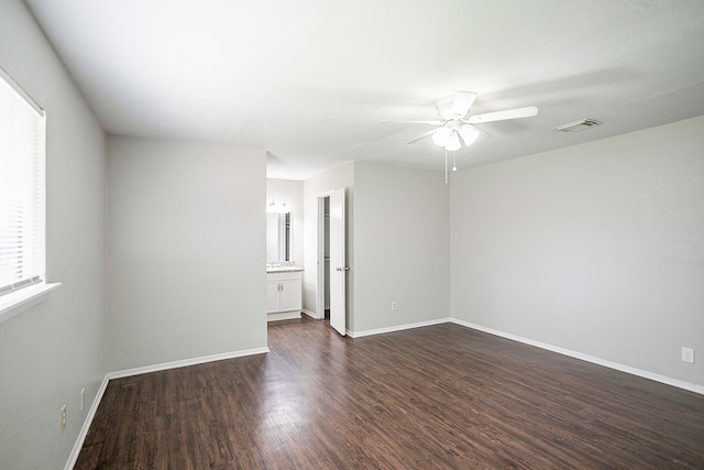 spare room with dark wood-type flooring and ceiling fan