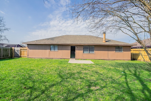 rear view of property with a yard