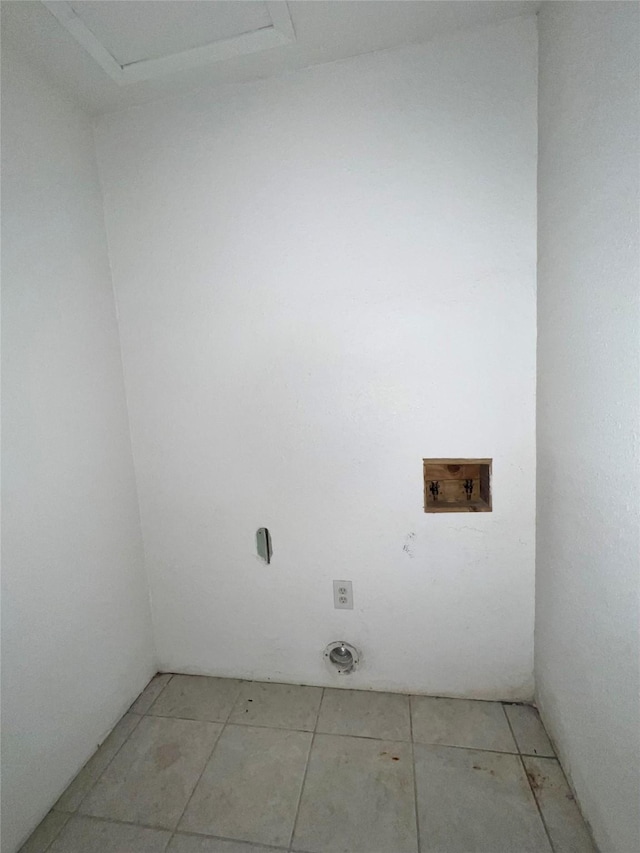 clothes washing area featuring washer hookup and light tile patterned floors