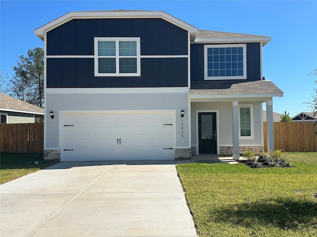 view of front of home featuring a garage and a front lawn