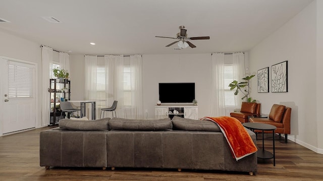 living room with ceiling fan and dark hardwood / wood-style floors