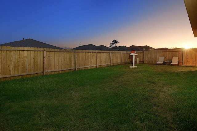 view of yard at dusk