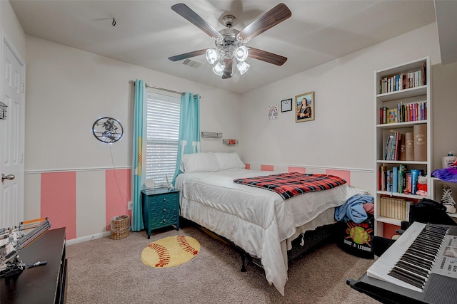 carpeted bedroom with a ceiling fan, visible vents, and baseboards