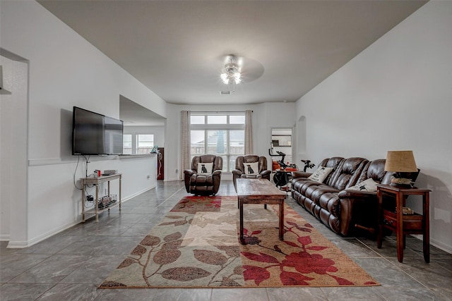 living area with arched walkways and baseboards