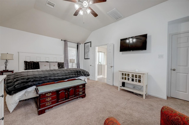 bedroom featuring lofted ceiling, baseboards, visible vents, and light colored carpet