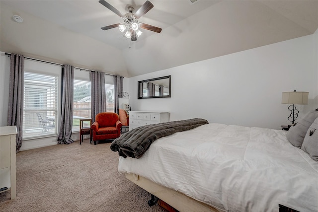 bedroom featuring lofted ceiling, a ceiling fan, and light colored carpet