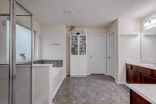 full bathroom with a garden tub, vanity, visible vents, baseboards, and a stall shower