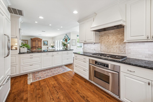 kitchen with custom exhaust hood, white cabinets, dark wood-style floors, and stainless steel appliances