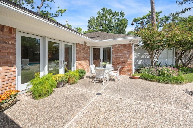 view of patio / terrace with outdoor dining space, french doors, and fence