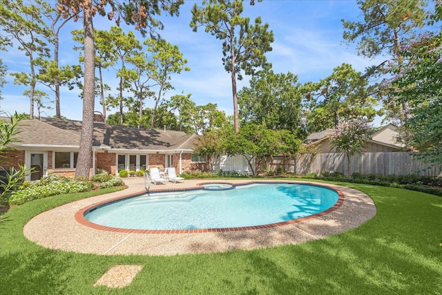 view of swimming pool featuring a fenced in pool, fence, an in ground hot tub, a patio area, and a lawn